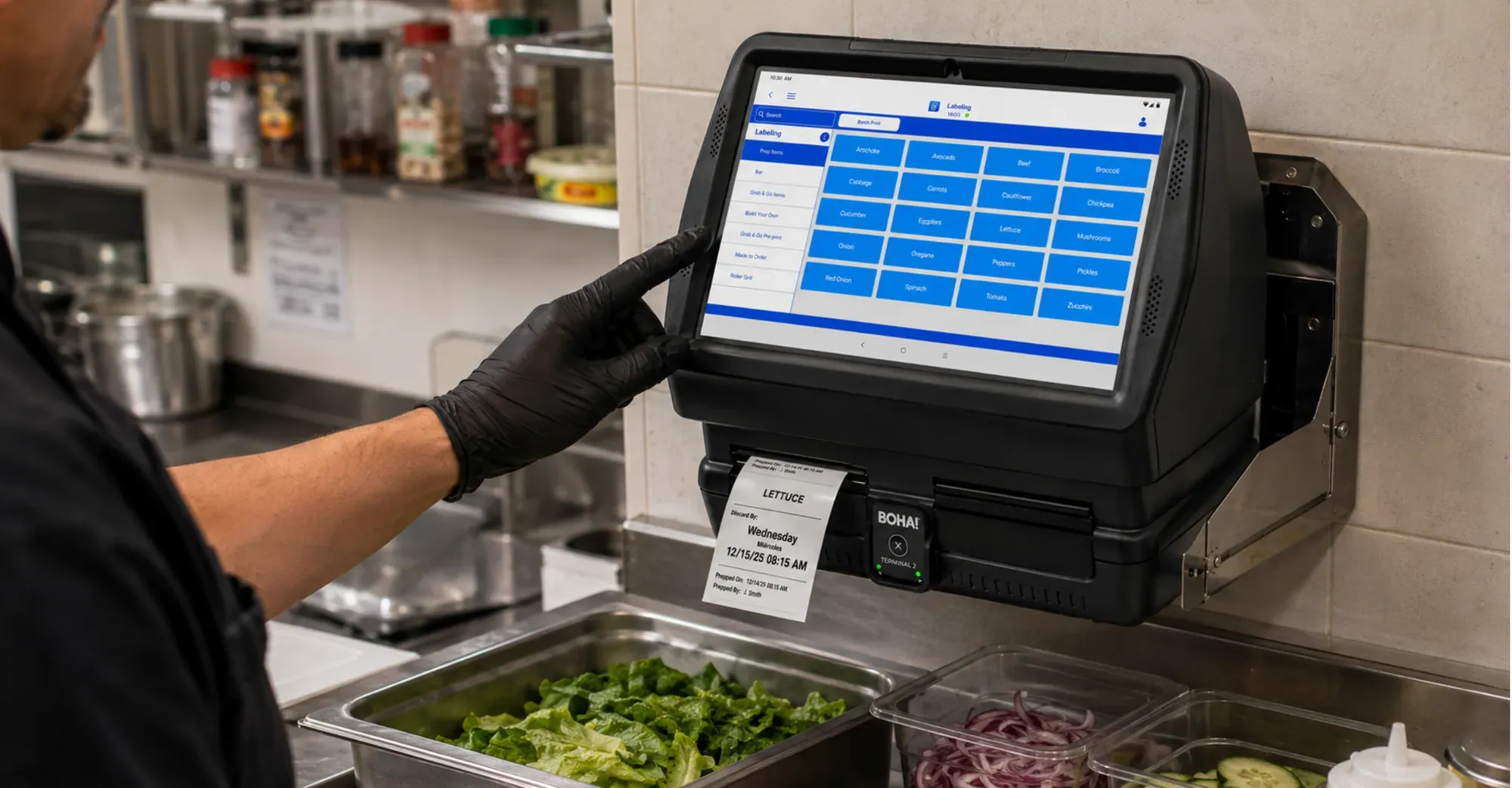 BOHA! Terminal 2 mounted above a commercial prep station printing a lettuce prep label in a back-of-house kitchen.