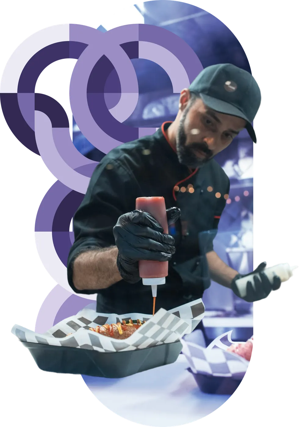 A foodservice worker plating food at a concession counter amid purple circular brand graphics