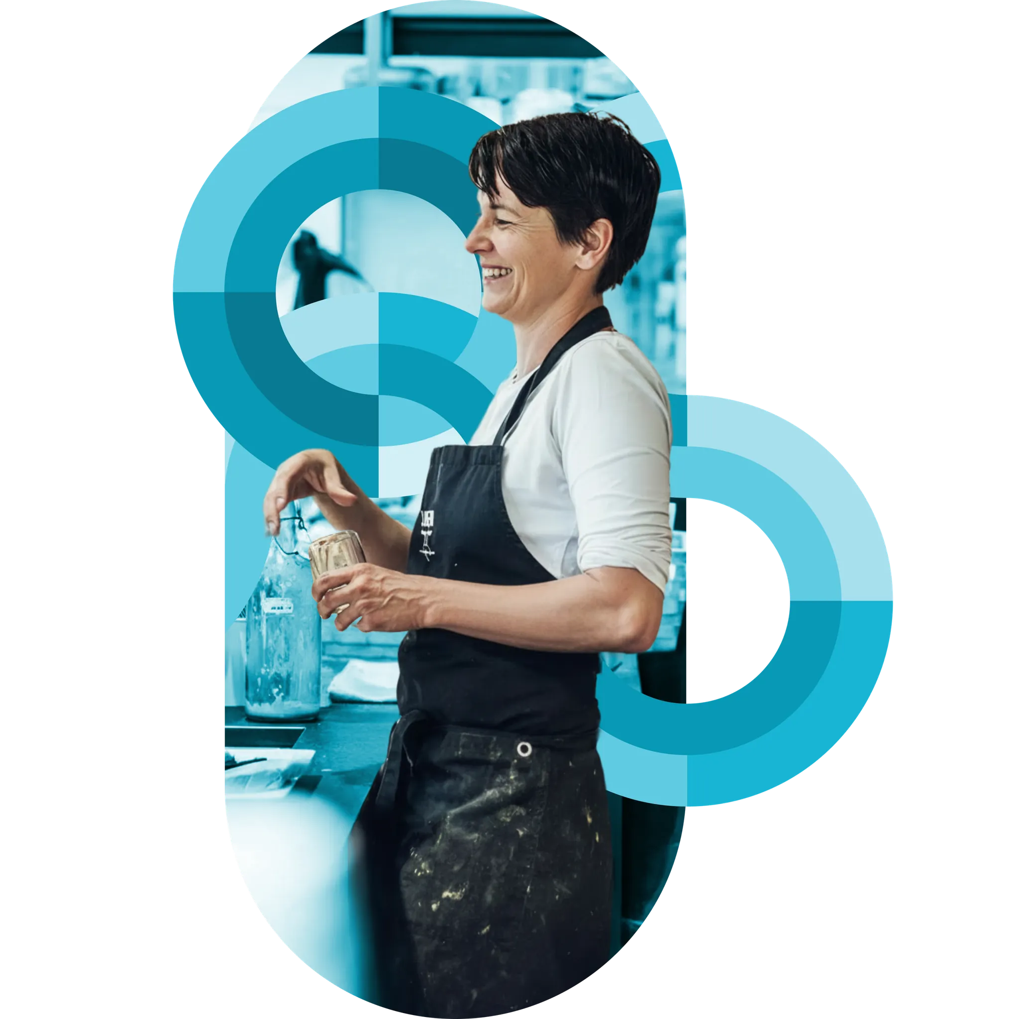 A kitchen team member in an apron working at the prep line, framed by teal circular brand graphics