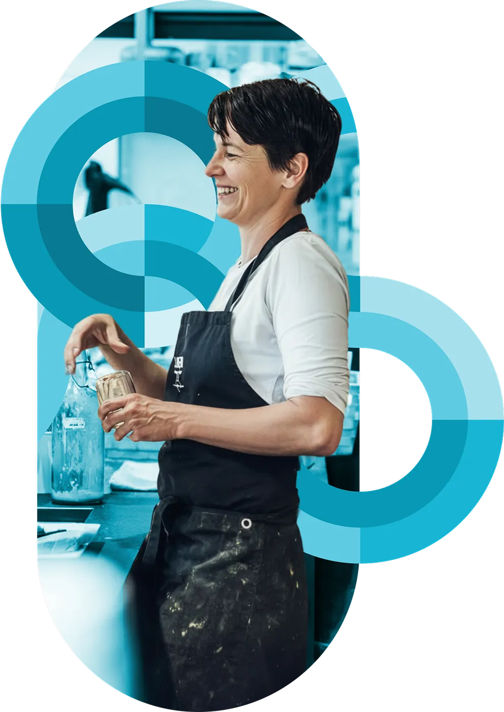 A kitchen team member at the prep line amid teal circular brand graphics