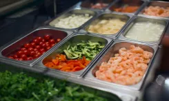 Organized restaurant food prep station demonstrating standardized workflow and food safety processes for operational efficiency